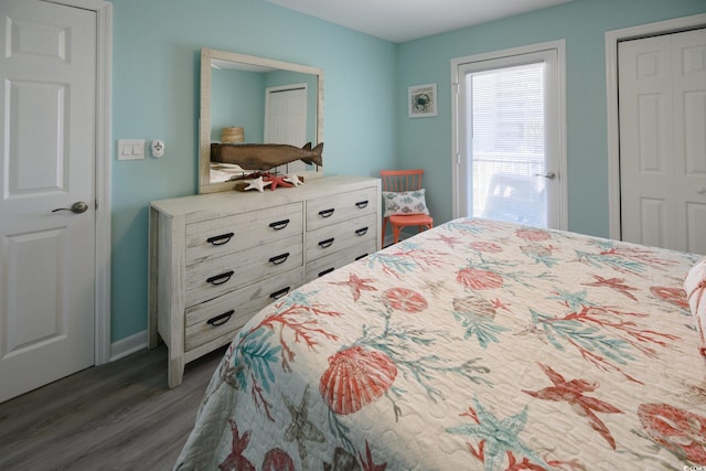 bedroom with dark hardwood / wood-style flooring