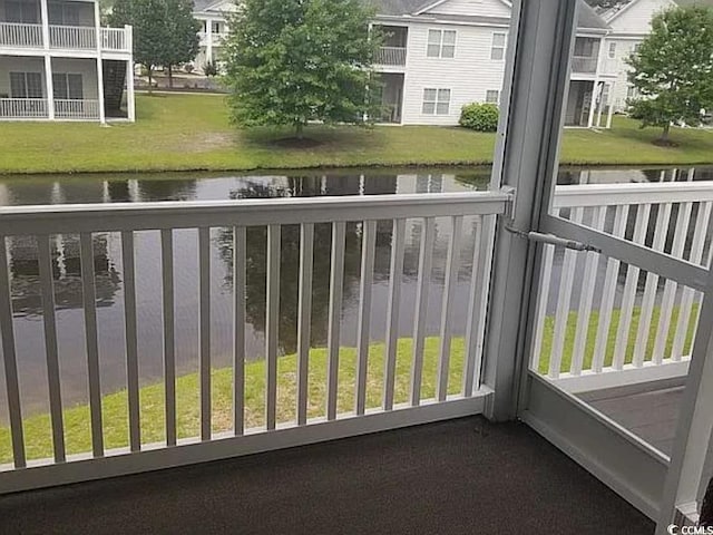 balcony featuring a water view