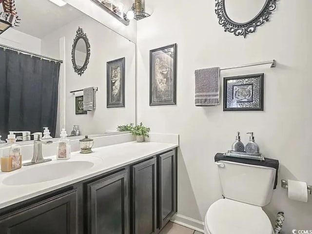 bathroom with vanity, tile patterned floors, and toilet