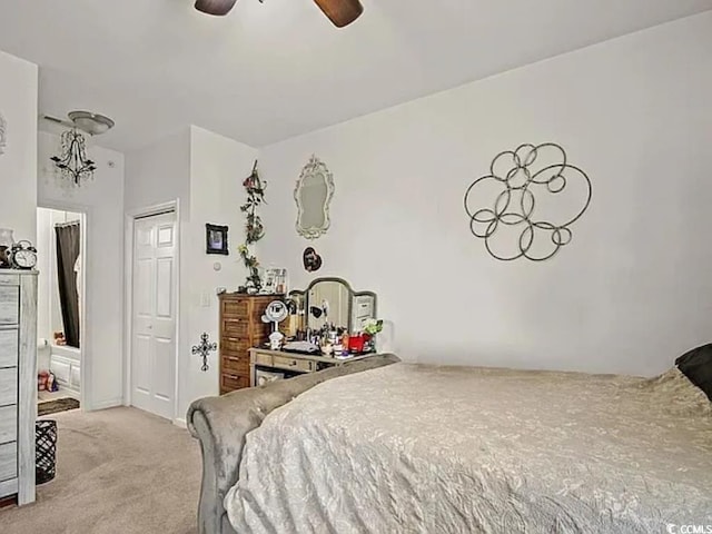 bedroom featuring ceiling fan, light colored carpet, and a closet