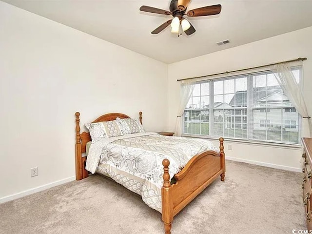 bedroom with ceiling fan and light colored carpet