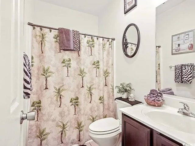 bathroom with vanity, toilet, and a shower with shower curtain