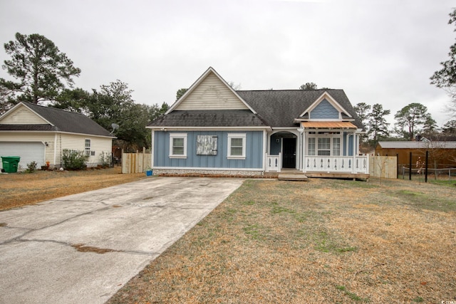 view of front of house with a garage, an outdoor structure, and a front yard