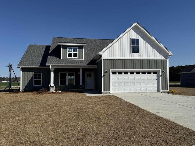 modern farmhouse with board and batten siding, concrete driveway, a shingled roof, and an attached garage