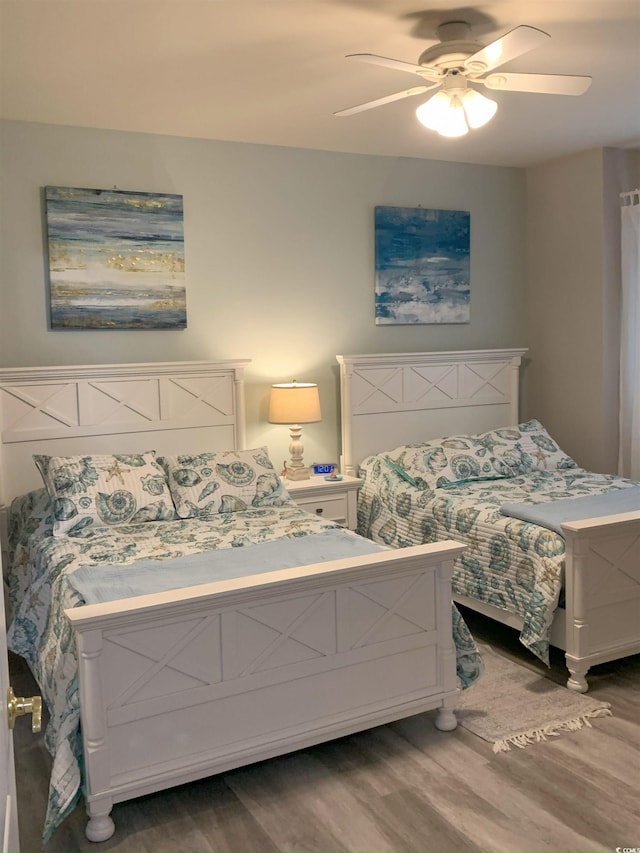 bedroom with hardwood / wood-style floors and ceiling fan