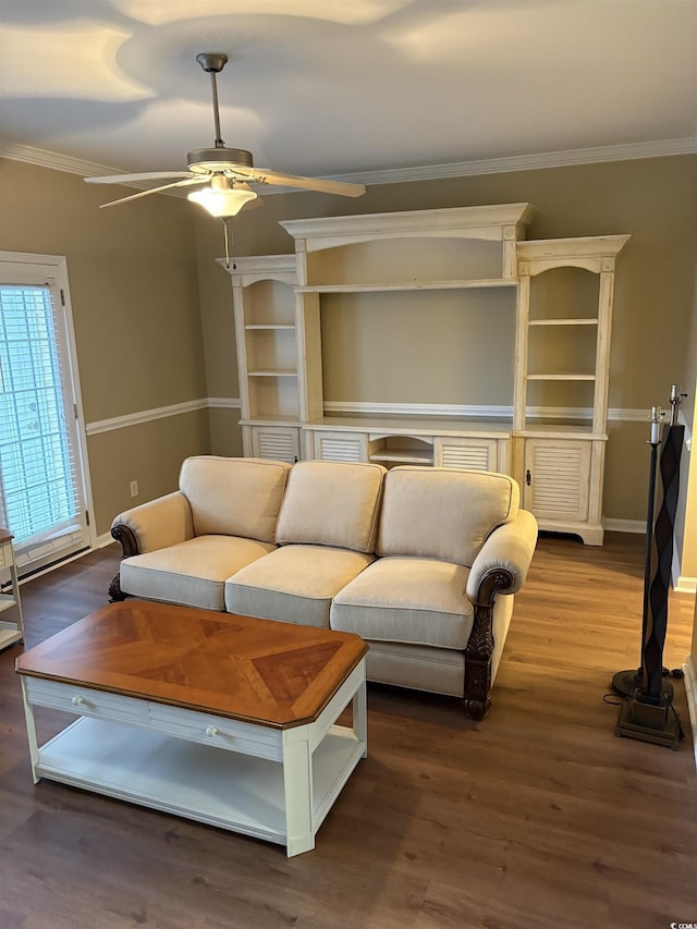 living room featuring crown molding, dark wood-type flooring, and ceiling fan