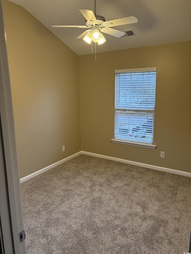 carpeted spare room featuring ceiling fan