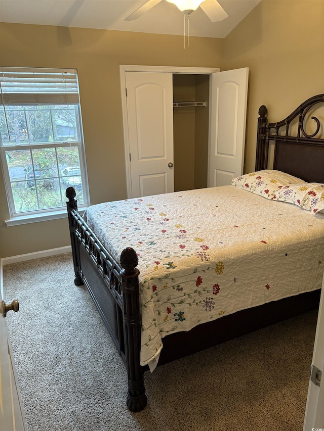 bedroom featuring vaulted ceiling, carpet floors, ceiling fan, and a closet