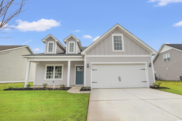 view of front facade featuring covered porch, board and batten siding, a front yard, a garage, and driveway