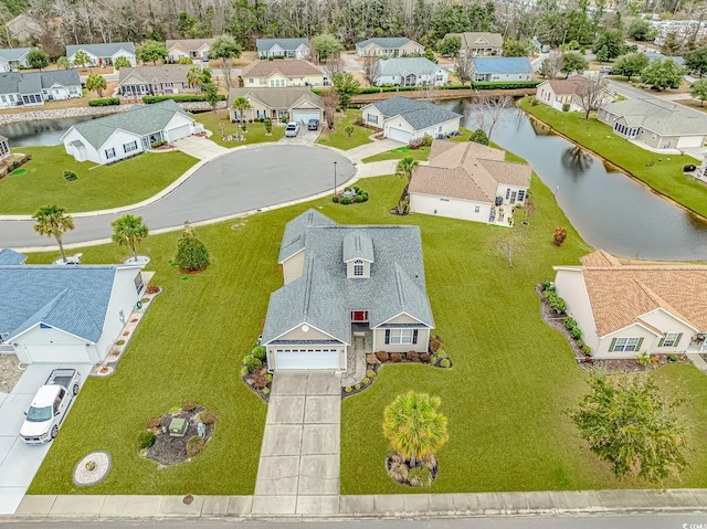 bird's eye view with a residential view and a water view