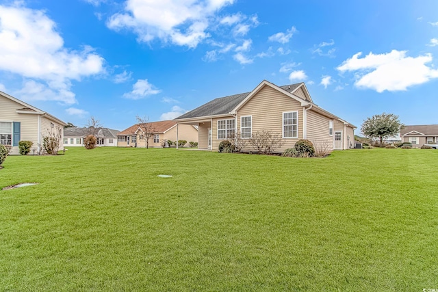 rear view of property featuring a yard