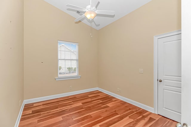 empty room with a ceiling fan, lofted ceiling, light wood-style flooring, and baseboards