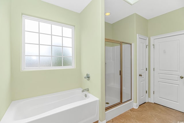 bathroom with a shower stall and a bath