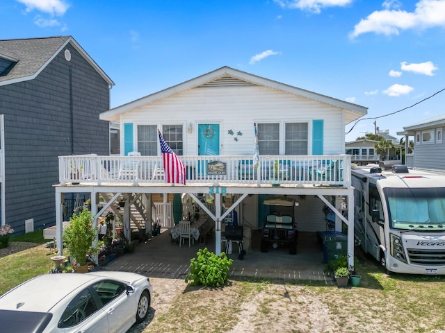315 60th Ave N, North Myrtle Beach, SC 29582 - view of front of home featuring a carport, driveway, stairway, and covered porch
