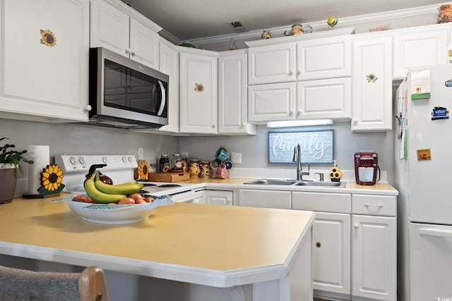 kitchen featuring a sink, light countertops, white cabinets, and white appliances