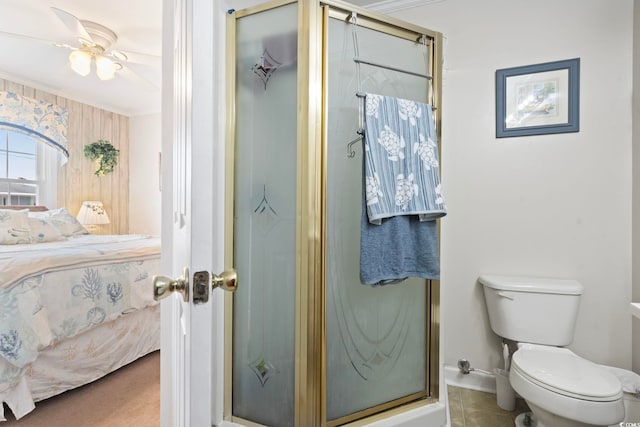 ensuite bathroom featuring toilet, ensuite bath, a stall shower, and baseboards