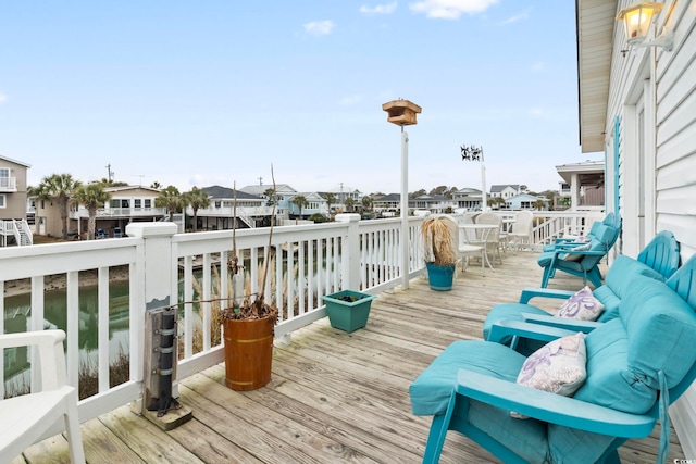deck featuring a residential view and a water view