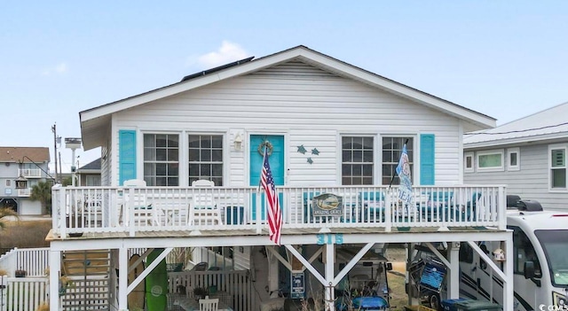 rear view of property featuring stairs