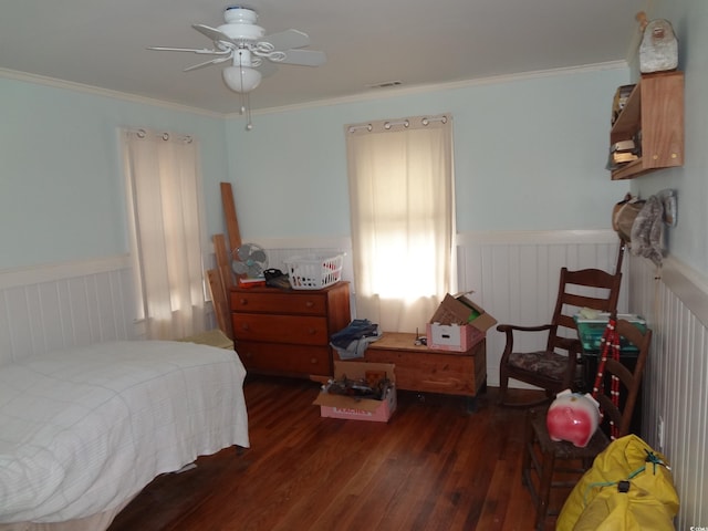 bedroom with dark wood-type flooring, ceiling fan, and crown molding