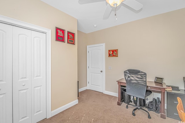 office space featuring light carpet, ceiling fan, and baseboards