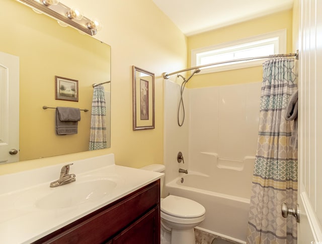 bathroom featuring vanity, toilet, and shower / bath combo with shower curtain