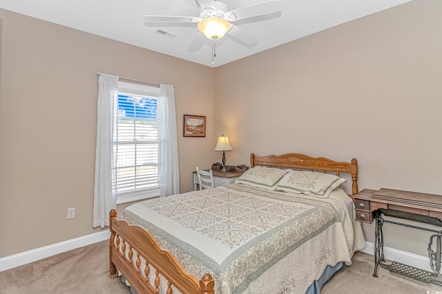 bedroom with a ceiling fan, visible vents, light carpet, and baseboards