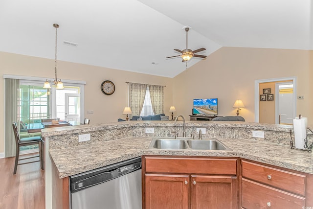 kitchen with open floor plan, light countertops, a sink, and stainless steel dishwasher