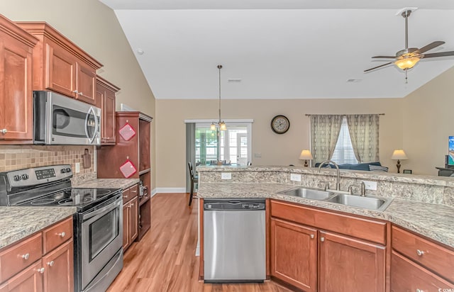 kitchen featuring vaulted ceiling, stainless steel appliances, and light countertops