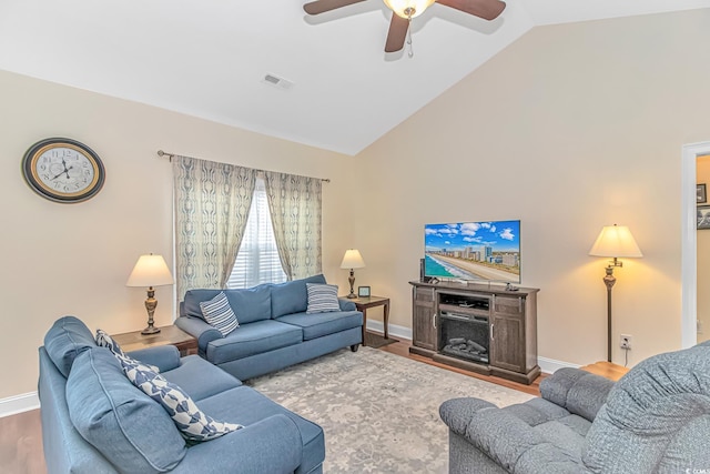 living room with visible vents, ceiling fan, wood finished floors, high vaulted ceiling, and baseboards