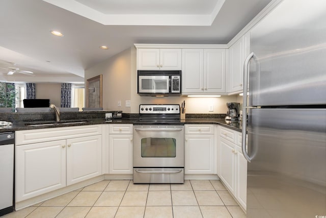 9994 Beach Club Dr Unit 1601, Myrtle Beach, SC 29572 - kitchen with stainless steel appliances, a tray ceiling, a sink, white cabinetry, and recessed lighting