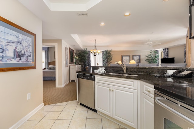 9994 Beach Club Dr Unit 1601, Myrtle Beach, SC 29572 - kitchen featuring stainless steel appliances, a sink, a tray ceiling, white cabinetry, and light tile patterned floors