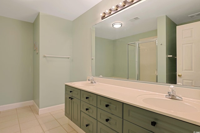 bathroom featuring tile patterned flooring, an enclosed shower, and vanity