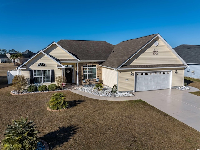 ranch-style house featuring a garage and a front yard