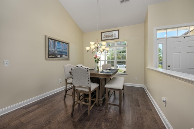 dining room with high vaulted ceiling, dark hardwood / wood-style floors, and an inviting chandelier