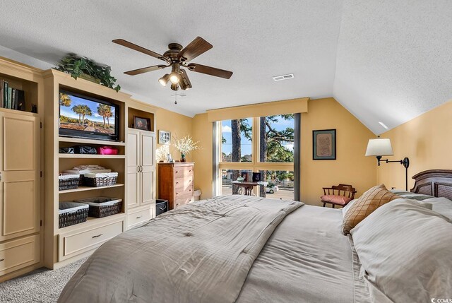 1800 Glenns Bay Rd, Surfside Beach, SC 29575 - bedroom with ceiling fan, lofted ceiling, light carpet, and a textured ceiling