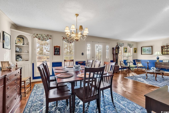 1800 Glenns Bay Rd, Surfside Beach, SC 29575 - dining space featuring a healthy amount of sunlight, ornamental molding, dark wood-type flooring, and a textured ceiling