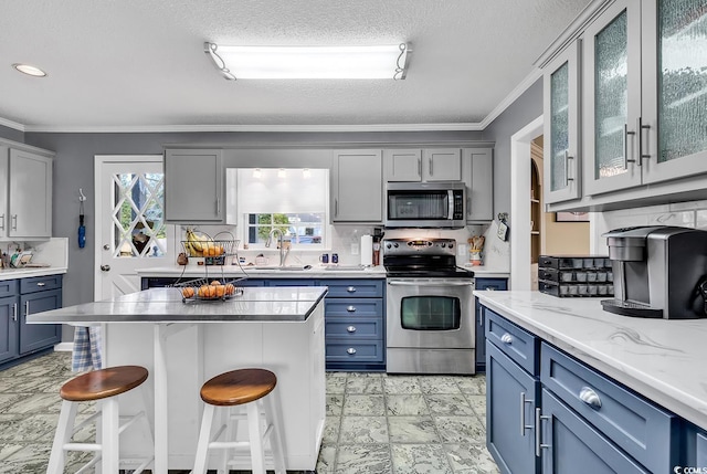 1800 Glenns Bay Rd, Surfside Beach, SC 29575 - kitchen with a breakfast bar, tasteful backsplash, a center island, appliances with stainless steel finishes, and ornamental molding