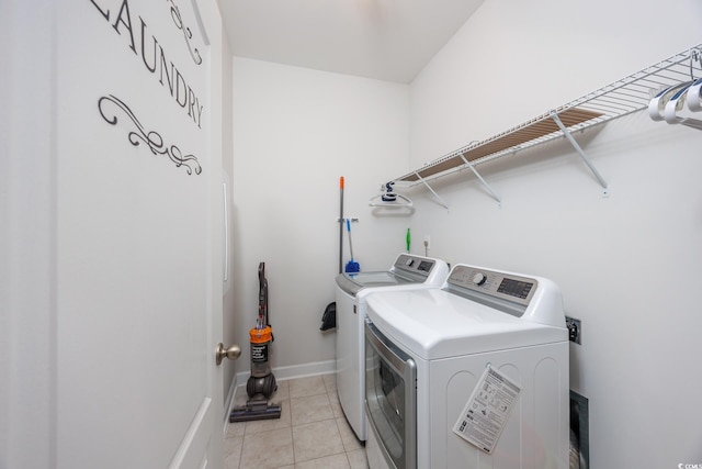 laundry room featuring light tile patterned floors and washer and clothes dryer