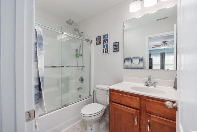 full bathroom featuring tile patterned flooring, enclosed tub / shower combo, vanity, ceiling fan, and toilet