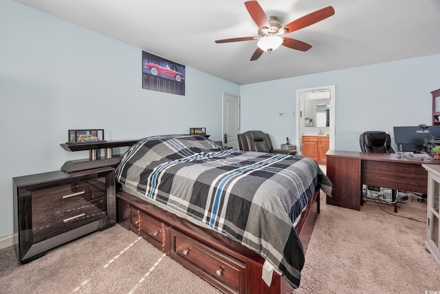 bedroom with ceiling fan, light colored carpet, and ensuite bathroom