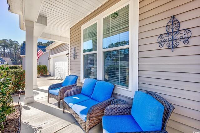 view of patio / terrace featuring a garage and covered porch