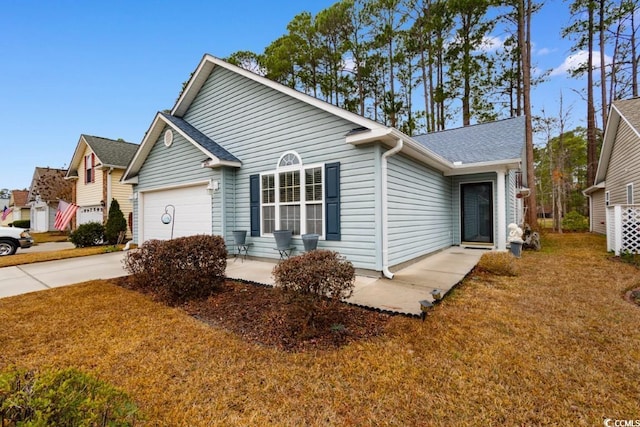 single story home with a garage and a front lawn