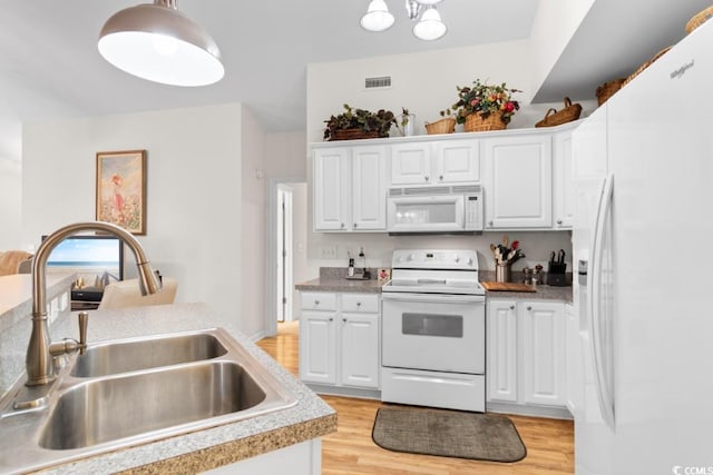 kitchen with sink, white cabinetry, decorative light fixtures, light hardwood / wood-style flooring, and white appliances