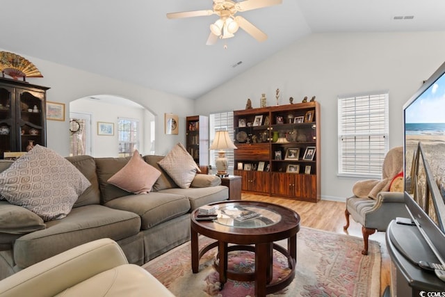 living room with vaulted ceiling, ceiling fan, and light hardwood / wood-style flooring