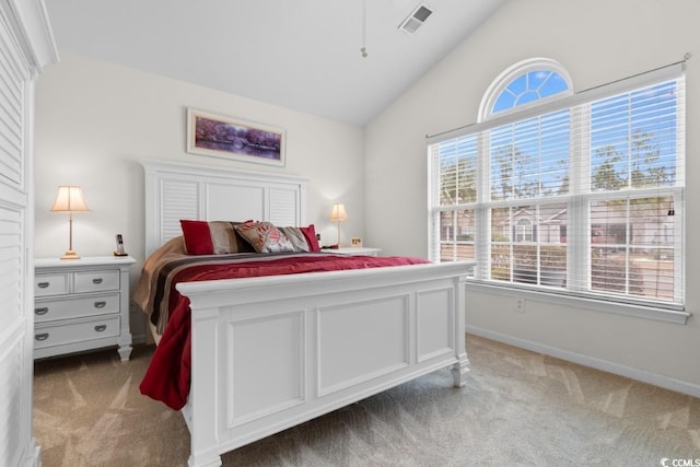 bedroom featuring vaulted ceiling and light carpet