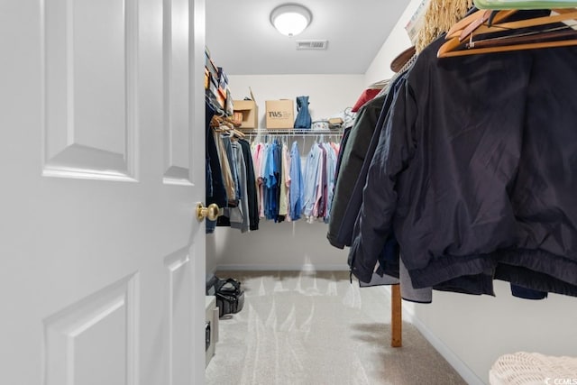 spacious closet featuring light carpet