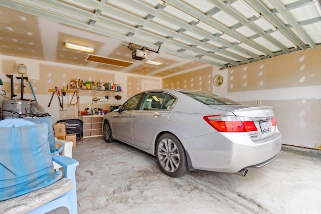 garage featuring a garage door opener and water heater