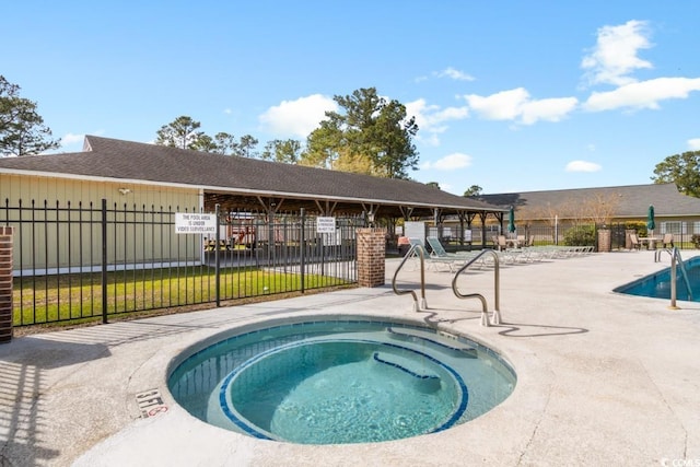 view of pool with a hot tub and a patio