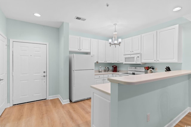 395 S Crow Creek Dr Unit 1418, Calabash, NC 28467 - kitchen with white appliances, a chandelier, a peninsula, white cabinets, and light countertops