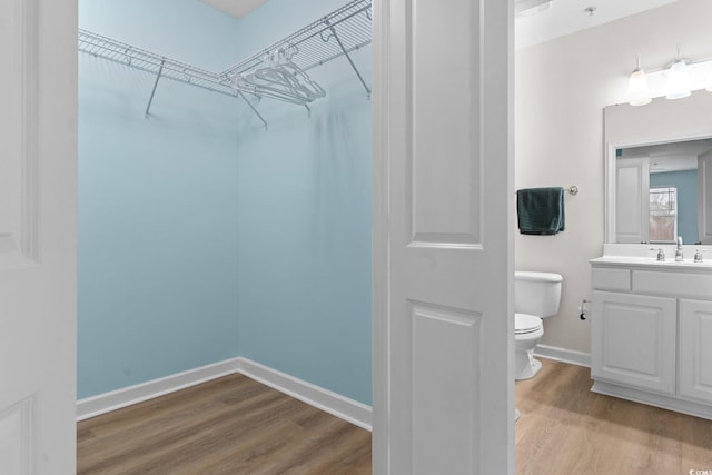 395 S Crow Creek Dr Unit 1418, Calabash, NC 28467 - bathroom featuring toilet, wood finished floors, vanity, baseboards, and a spacious closet
